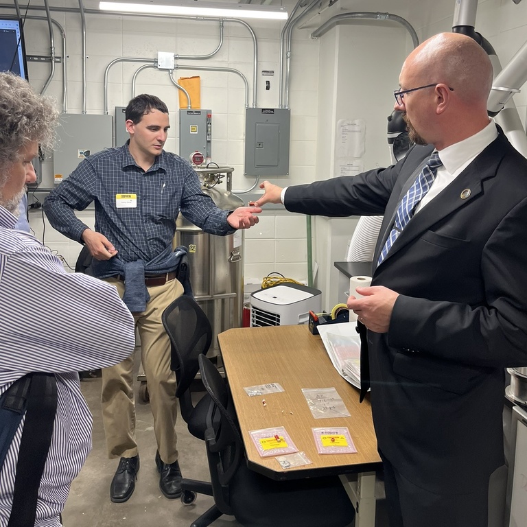 David Miles shows a coil to Sanny Omar