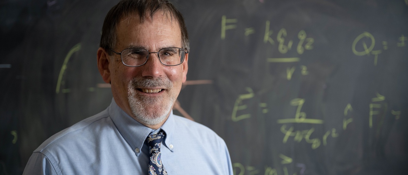 Craig Kletzing in front of a blackboard